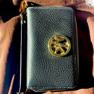 Black Michael Kors wristlet with gold MK. LIKE NEW